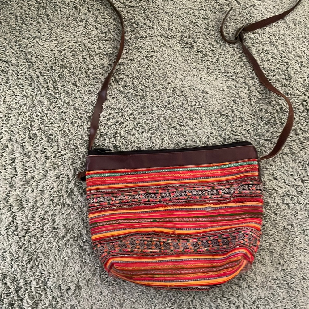 Woven messenger bag with leather strap